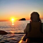 Photo Showing A Woman Kayaking and A Beautiful Sunset